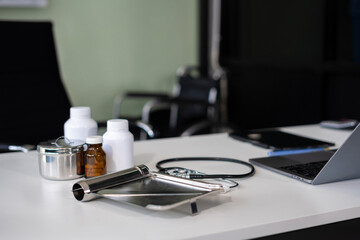 Top view of doctor desk table with stethoscope, coffee, Medical gown and notebook with pen.