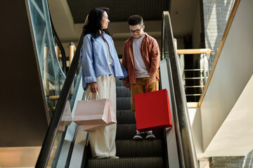 A mother and her son with Down syndrome share a happy moment together on an escalator in a shopping...