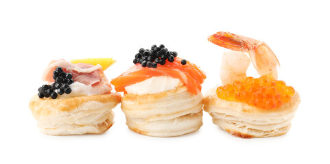 Different delicious puff pastry snacks isolated on white