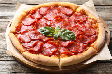 Tasty hot pepperoni pizza on wooden table, closeup