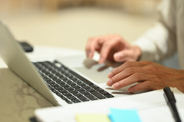 Close up of unrecognizable businessman typing at laptop keyboard remote work, browsing internet in office