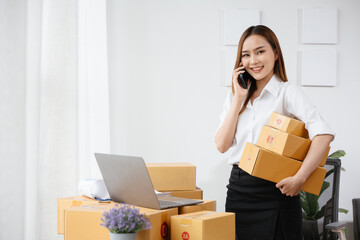 Owner SME Small and Medium Enterprises woman received orders from clients on phone and laptop then...