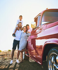 Parents, children and smile with car for road trip, adventure and explore on holiday, weekend or vacation. Travel, vintage pickup truck and mother, father and kids for journey and bonding together © JorSons/peopleimages.com