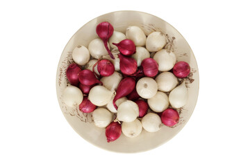 Onion in a clay plate isolate on white background. Salad purple and white onion in rustic bowl.