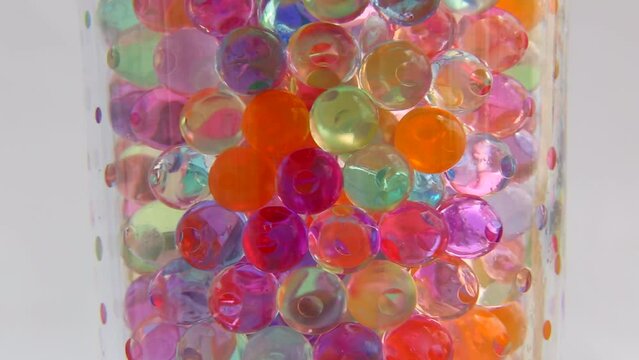 ASMR rotation of colored balls. Hydrogel balls in a transparent glass rotate endlessly in a loop . 