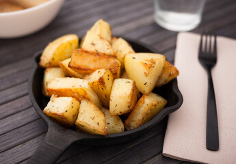 Golden fried potatoes on small cast iron skillet