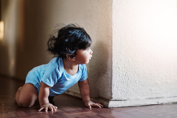 Baby, crawling and floor for play at house with learning mobility development, motor growth and explore of freedom. Child, boy and curious with muscle health, adventure and balance support at home