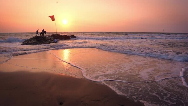 Wide angle shot of sunset at the Goa beach in India. View of the beach during the sunset. Summer Holidays at beach background. Beautiful sunset at beach