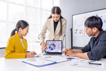 Fototapeta premium Group of casually dressed asian businesspeople discussing ideas in the office. Creative professionals gathered at the meeting table for discuss important issues of the new successful startup project 