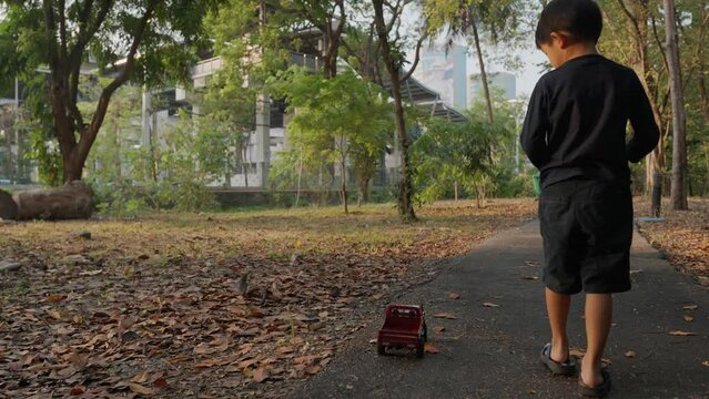 Adorable kid boy and girl enjoying play remote control car truck outdoor city forest park playful kid