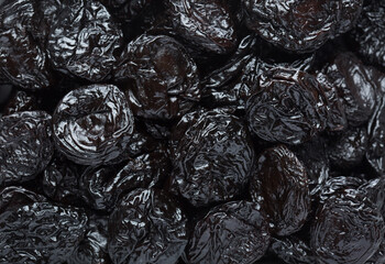  Close-up of Prunes (dried Prune Plums) as background. Selective focus. Flat lay