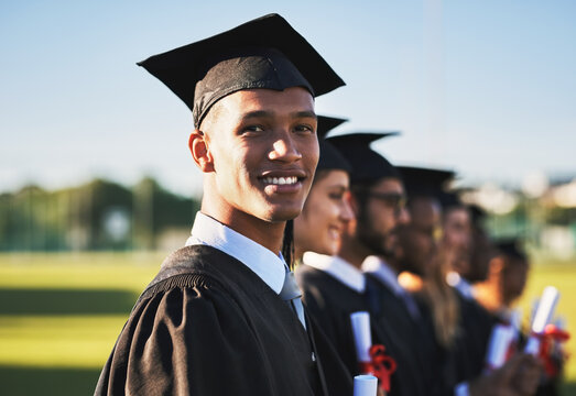 Celebration, graduation and portrait of university student outdoor on campus with friends for ceremony or event. Diversity, education and future with happy graduate man at college for success