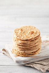 Homemade Indian Traditional Flatbread called Chapati on a white wooden background. Baked indian flatbread. Indian