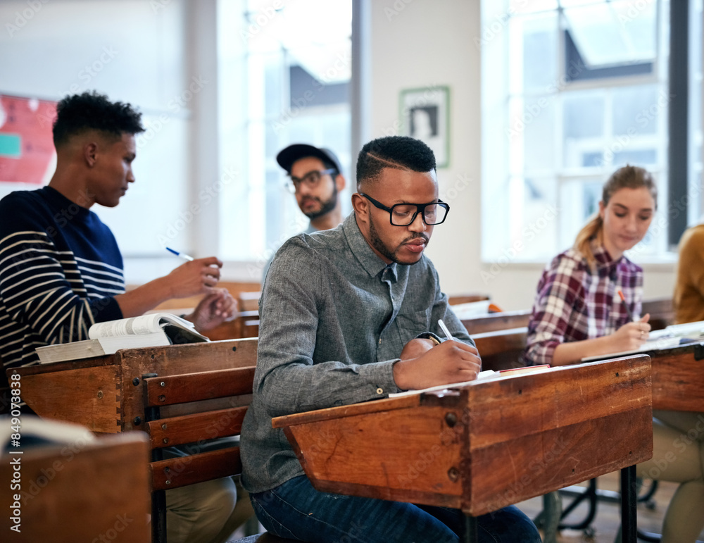 Leinwandbilder Classroom, university and group of students with exam for education, scholarship or studying. College, knowledge and young people write notes for learning in lecture for test or assignment at campus.