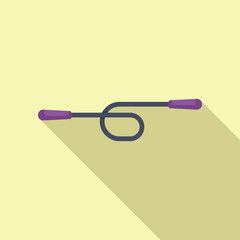 Jump rope lying on the ground casting a long shadow over a yellow background