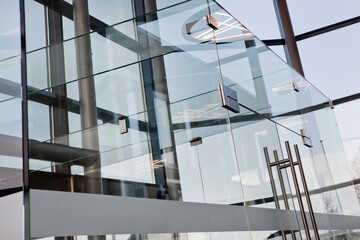 Application of glass in a modern Dutch office. Modern architecture. Glass doors. Chrome. 