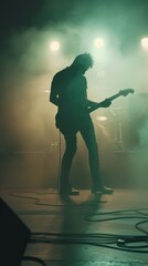 A man playing a guitar in a dark room with smoke