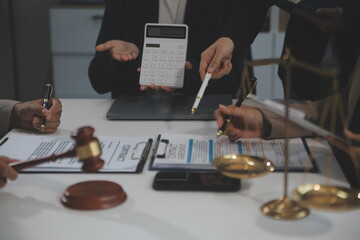 Judge gavel with Justice lawyers having team meeting at law firm background. Concepts of Law and Legal services.