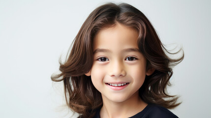 Fototapeta premium Portrait of a cute handsome happy Asian boy child with long hair and perfect skin, white background, banner.