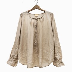 Beautiful girl in blouse on one shoulder . Fashionable and stylish women's clothing . Fashion look , beauty and style. Young woman in trendy jewelry earrings rings.