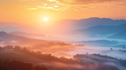 Fototapeta premium A beautiful sunrise over rolling hills and fog in a mountainous region.