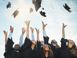 Students, graduation and caps in sky with happiness, university achievement or ceremony or excited people. Academic, goals and college degree completion, education success and excellence celebration