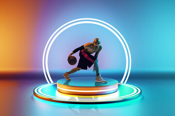 Focused man, basketball player in dynamic pose with ball on podium with led circle against colorful...