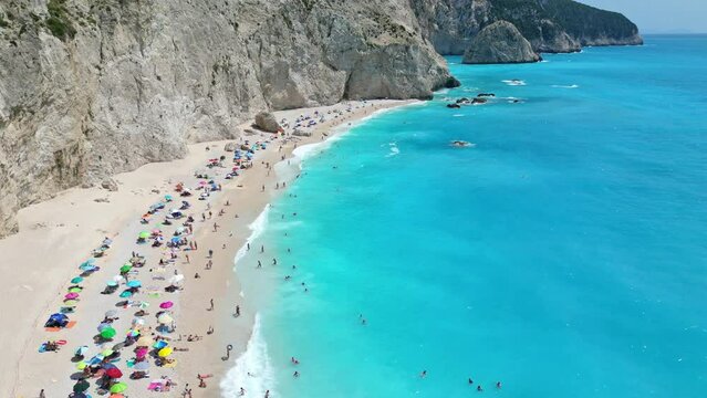 Aerial view of Porto Katsiki beach in Lefkada, Greece. Crowded with sunbathers and colorful umbrellas, the turquoise waters are crystal clear.