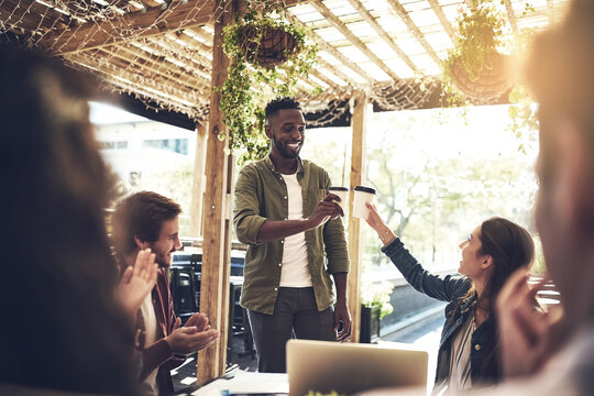 Business people, coffee and cheers with applause for team building, meeting or discussion at outdoor cafe. Young male person or happy group of employees clapping or toast for promotion at restaurant