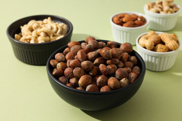 Various nuts in white and black bowls