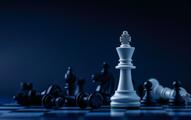 A white chess piece stands on the board, among fallen black pieces.