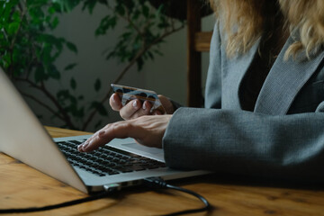 Online money transfer. Hands input bank payment card data using laptop.