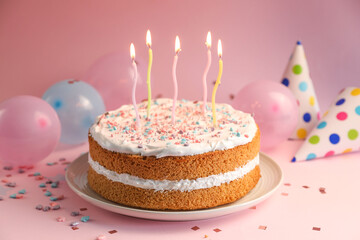 Tasty cake with colorful candles on pink background, closeup