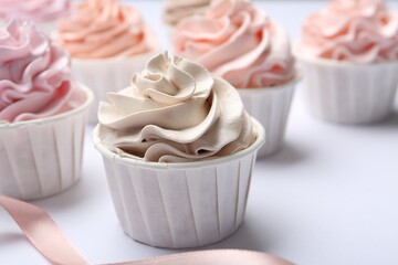 Many tasty cupcakes on white background, closeup