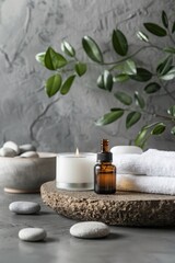 Tranquil Spa Scene: furnishing spa with towel, stones and oil on gray fuzzy background