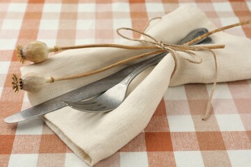 Stylish setting with cutlery and napkin on table, closeup