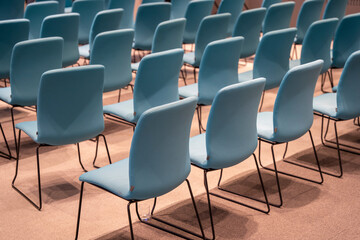 Rows of new blue chairs in the conference hall