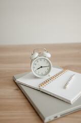 alarm clock on desktop, laptop and notebook for work.
