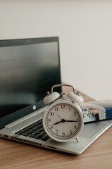 alarm clock on desktop, laptop and notebook for work.