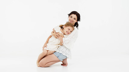 Mom's gentle touch.  Close-up of a touching and tender mother and daughter on a light background. Family concept.