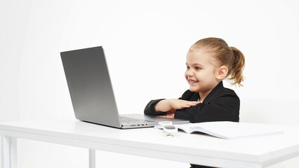 Stylish, business schoolgirl studying at a laptop on an isolated white background. Concept of modern technology, business and education.