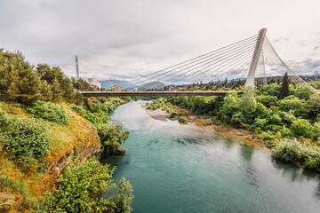 In Podgorica, Montenegro, the Moraca River serves as a captivating backdrop to the city's architecture and skyline, offering travelers a beautiful view of nature and historic buildings