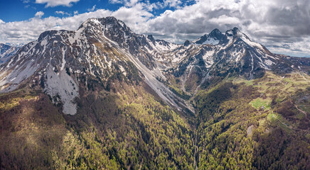 Stunning aerial spring landscape with blue skies, woods, and Komovi peaks in Montenegro