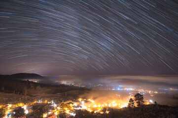 Star trails above mountain village in Tenerife