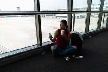 Female passenger waiting her flight at airport