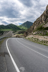 summer panoramic landscape of mountains and forest and waterfall against the sky in the area of ​​Lake Teletskoye in Altai