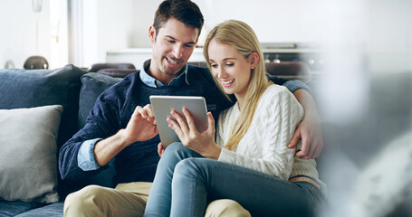 Couple, tablet and happy to relax on couch, video and streaming with subscription on web in living...