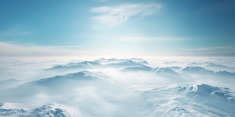 Image of multiple snow capped mountain peaks above the clouds under a clear sky