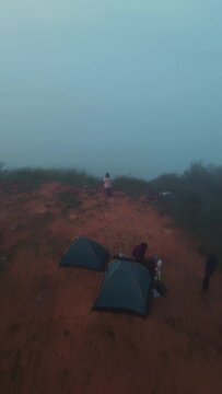 Vertical Footage of A Man Enjoying the Morning Atmosphere on Arang Hill, Gorontalo