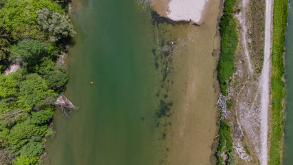 Isar river in Munich aerial view. South German river flowing down through a valley sorrounded by...